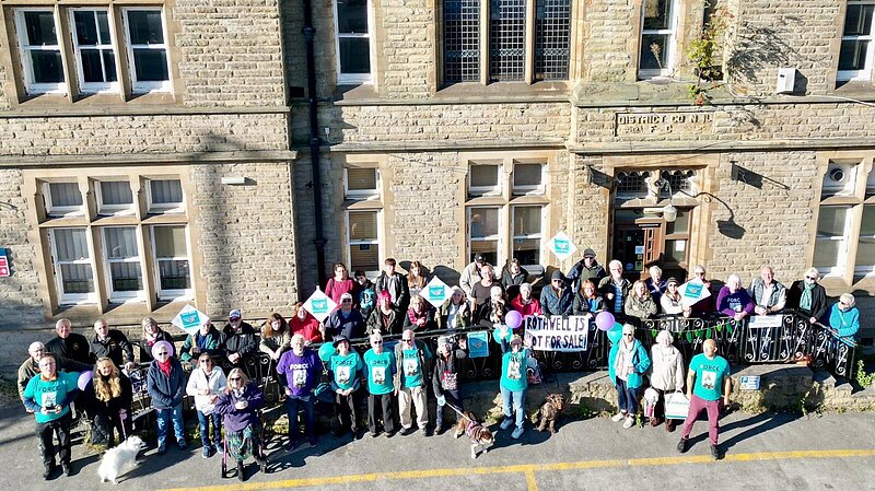 A crowd of people standing in front of the council offices in 