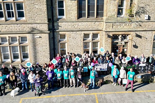 A crowd of people standing in front of the council offices in 