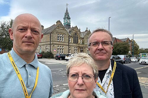 Stewart, Diane and Conrad standing in front of the council offices