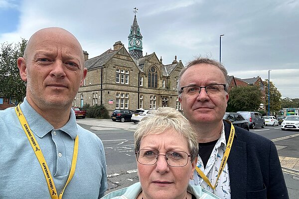 Lib Dem Councillors standing in front of the offices